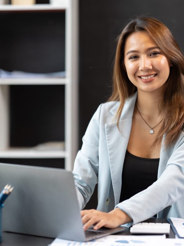 Asian woman working with laptop in her office. business financial concept.